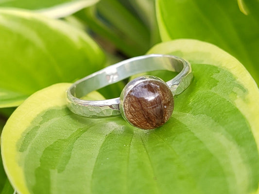 A handmade sterling ring with artisan "gem" crafted from a loved ones hair, fur, or ashes.