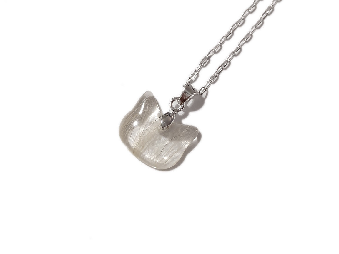 A cat shaped memorial pendant with small amount of fur inside