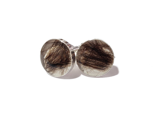 A pair of silver plated memorial cuff links with loved ones hair or fur inside.