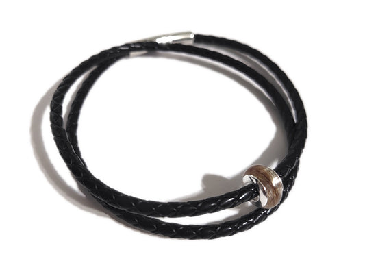 Handmade memorial bead with hair and silver rivets on black braided leather bracelet