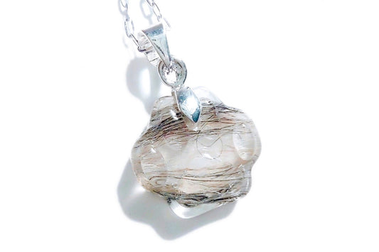 A handmade paw print necklace containing a beloved pets fur.