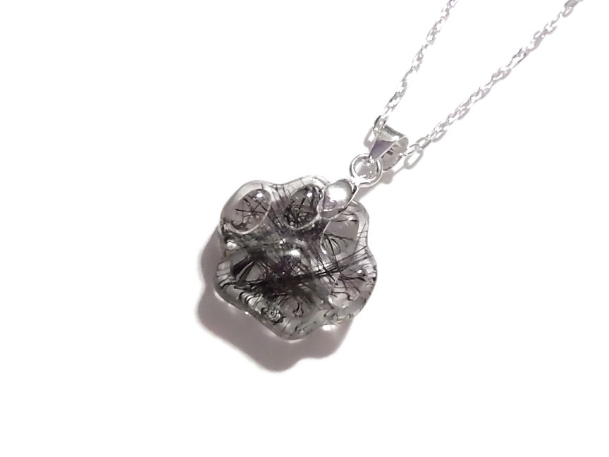 A small keepsake in the shape of a paw, with the beloved pets fir inside