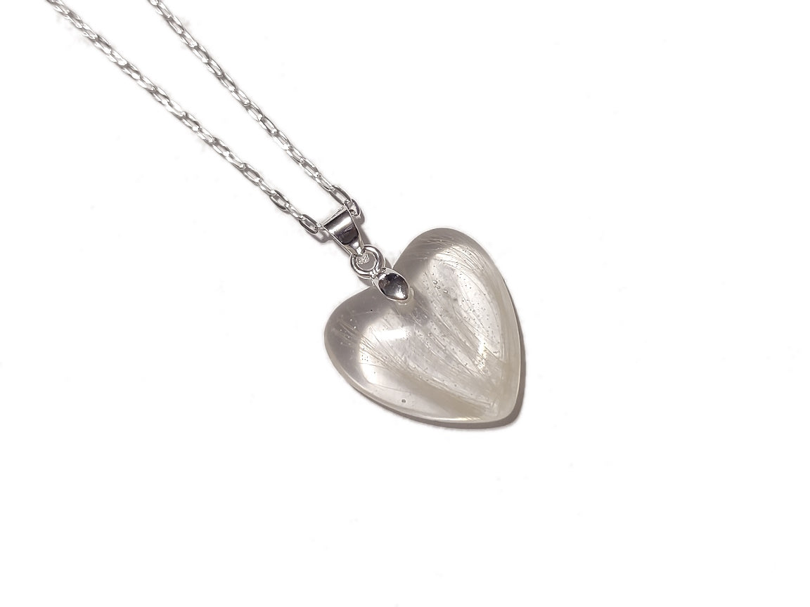 a small heart keepsake necklace with white hair