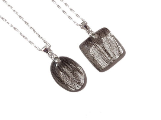 A comparison between the small oval hair keepsake and the square heir keepsake necklace