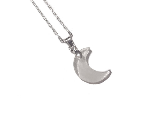 A tiny moon shaped memorial necklace with loved ones hair or fur
