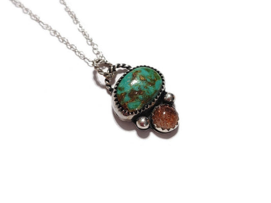 A handmade sterling necklace with a multihued earthy turquoise and shimmering orange sunstone.