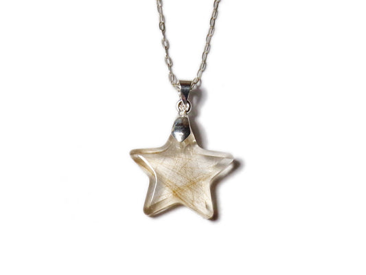 A small star shaped pendant encapsulating s lock of hair