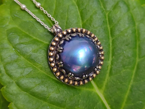 Blue pearl necklace on a green leaf