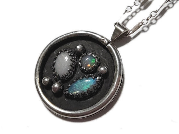 Necklace with a round pendant featuring stones on a white background