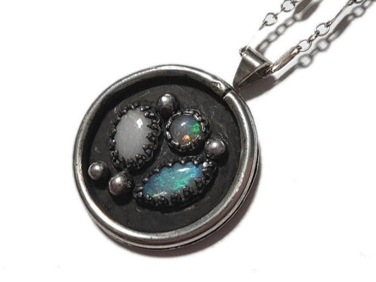 Necklace with a round pendant featuring stones on a white background