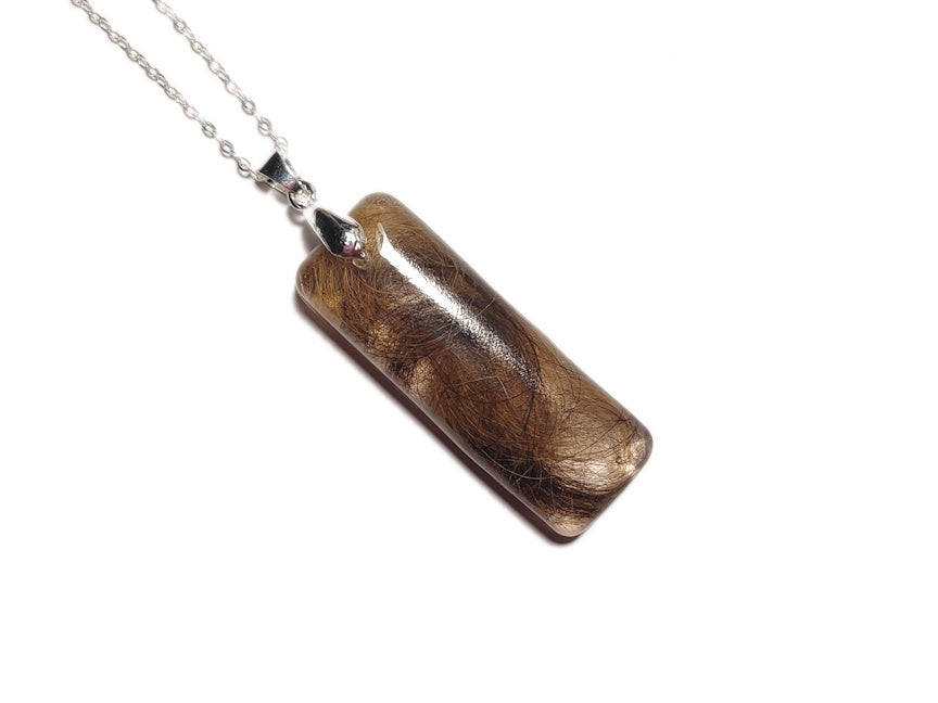 Pet fur memorial necklace on silver chain.