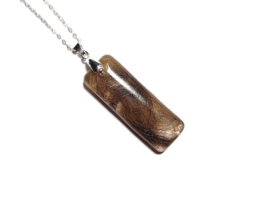 Pet fur memorial necklace on silver chain.