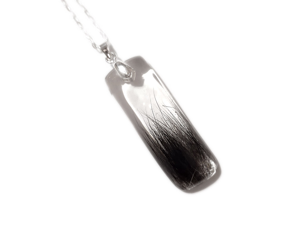 Handmade memorial pendant containing hair lock.