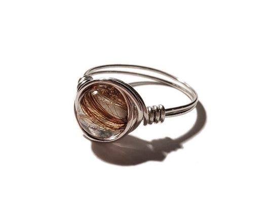 A sterling silver wire wrapped ring with a hair filled memorial bead.