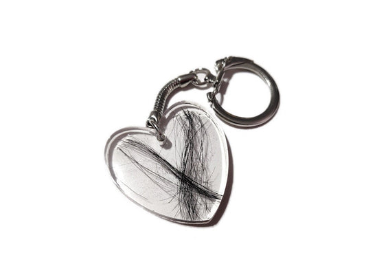A large flat heart shaped keychain with a loved ones hair