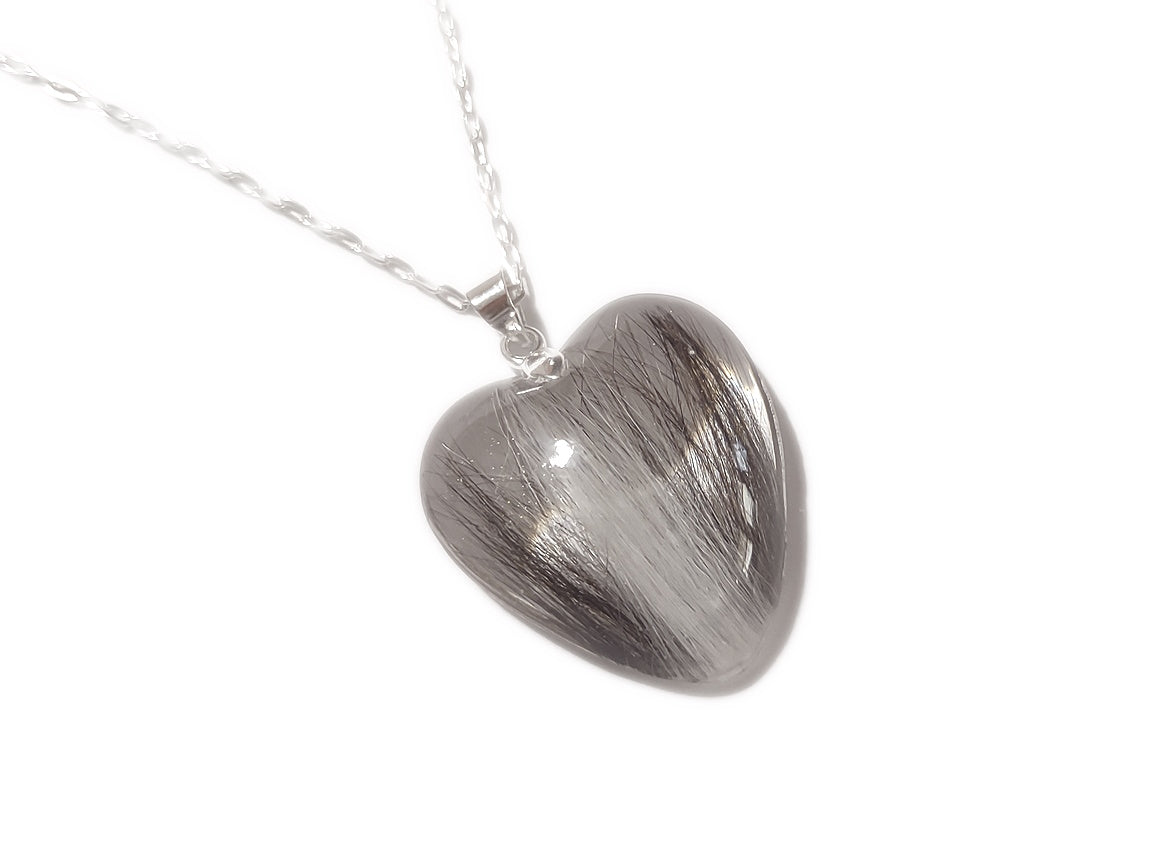 A handmade keepsake necklace in the heart shape with a loved ones hair, fur, or ashes.
