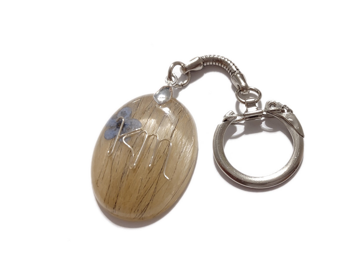 A memorial keychain with initials and hair