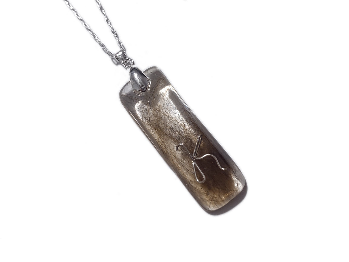 Handmade memorial pendant containing hair lock.