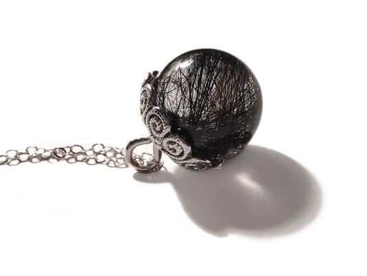 Keepsake hair necklace with sphere on silver chain.