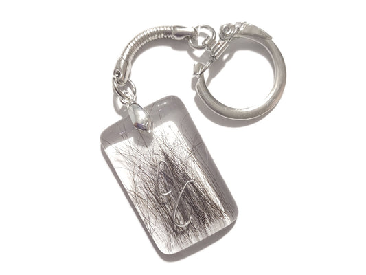 A hand crafted key chain encapsulating a loved ones hair