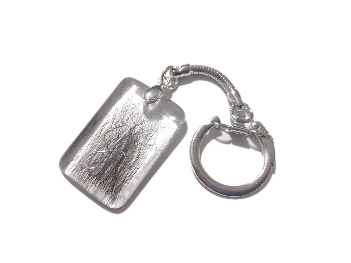 A memorial key chain with loved ones hair and intial