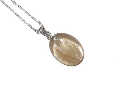 a small oval keepsake pendant with a small amount of light colored hair