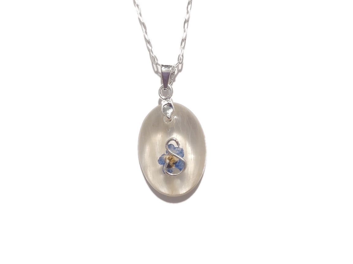 a small oval memorial necklace with white hair, the initial S, and a forget me not flower