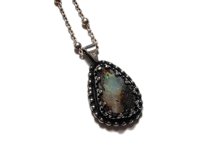 Handmade silver necklace with a pendant featuring a Yowah Boulder  opal stone on white background.