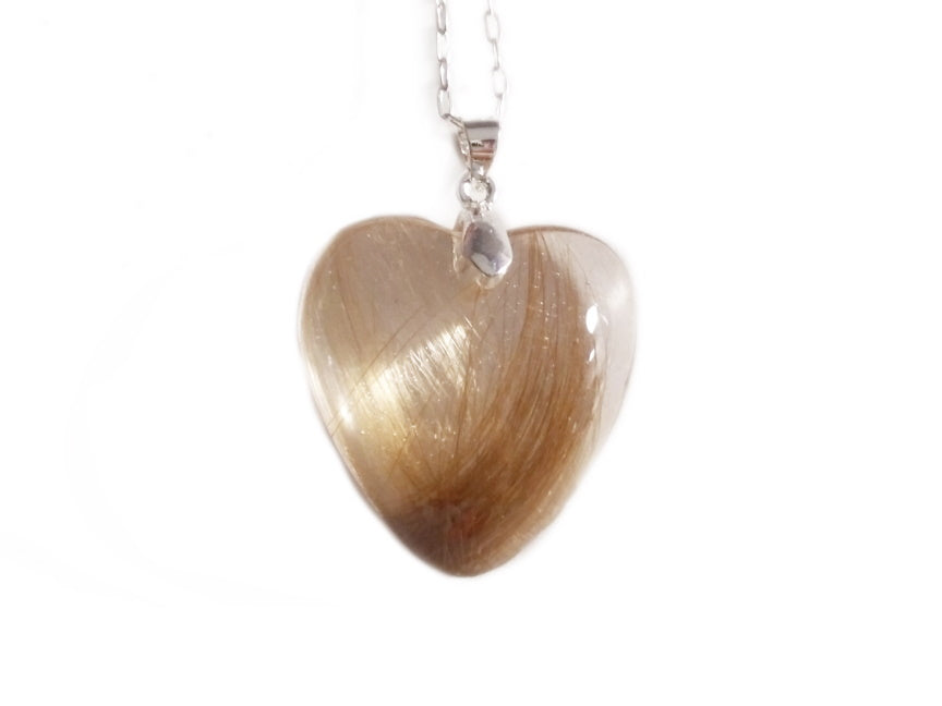 A handmade keepsake necklace in the heart shape with a loved ones hair, fur, or ashes.