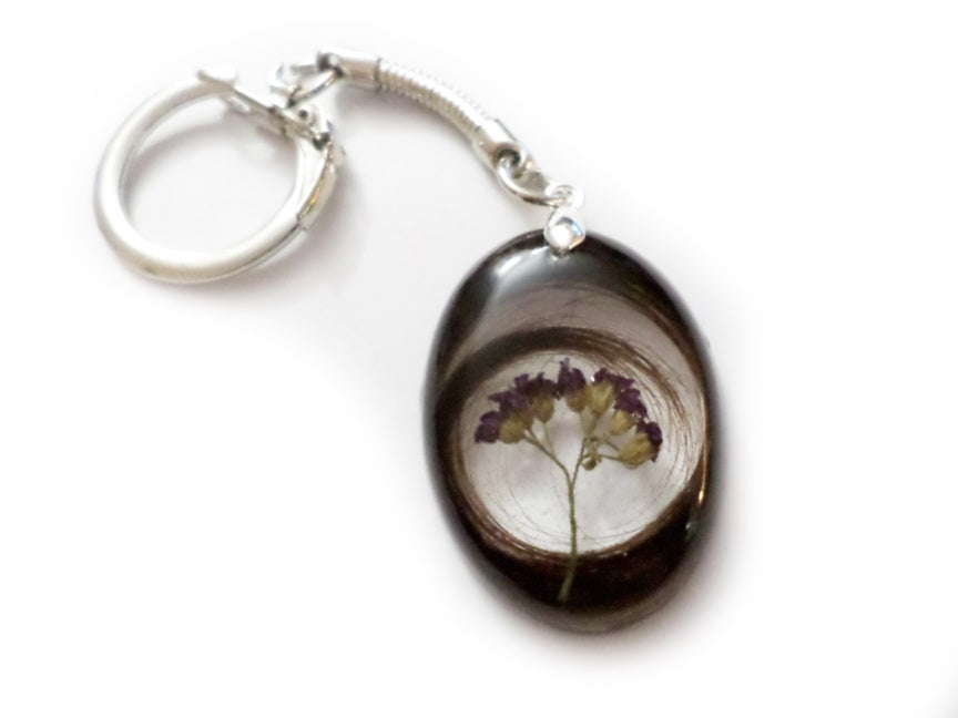 Handmade keychain containing a loved ones hair and flowers
