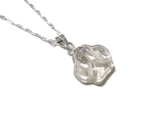 A handmade paw print necklace containing a beloved pets fur.