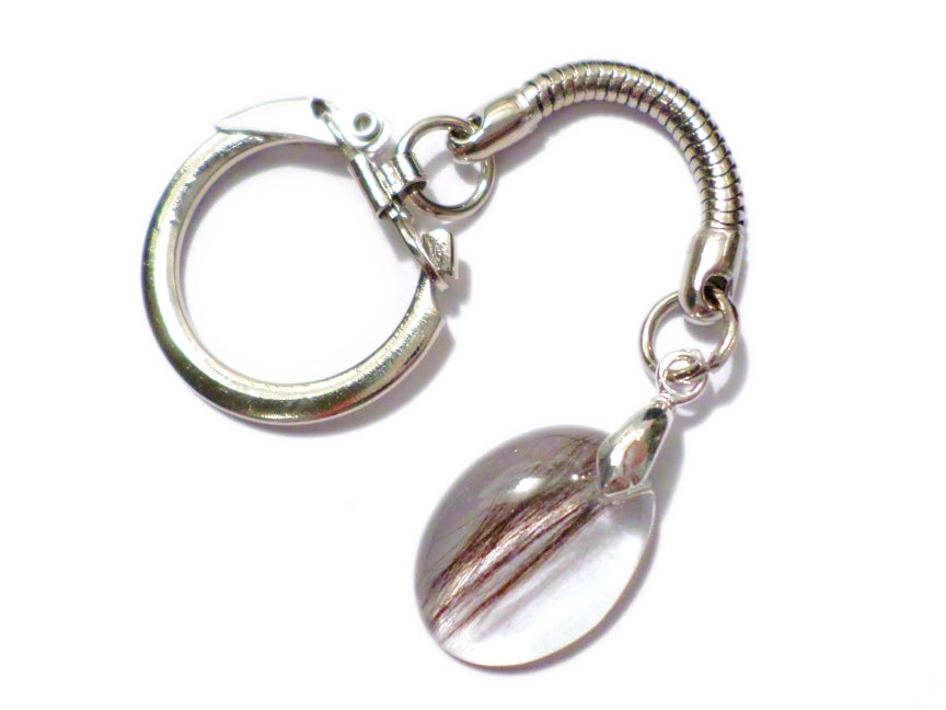A small oval memorial keychain with hair